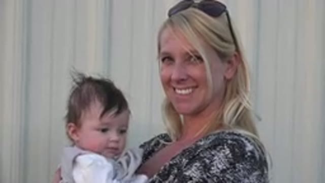 DENVER COLORADO-2015: Smiling Blonde Mother With Sunglasses Holding Child