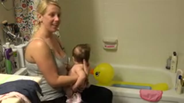 WESTMINSTER COLORADO-2015: Woman Wearing Gray Tank Top Prepares to Bathe Infant