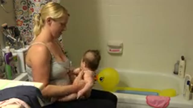 WESTMINSTER COLORADO-2015: Mother Preparing Her Child For Taking A Bath In A