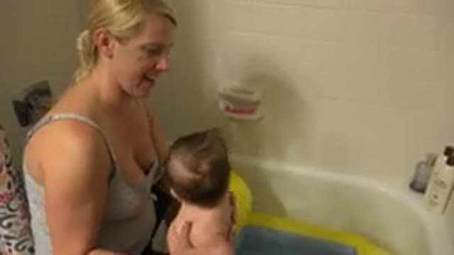 WESTMINSTER COLORADO-2015: Mother And Baby Playing With An Inflatable Toy In The Bath Tub