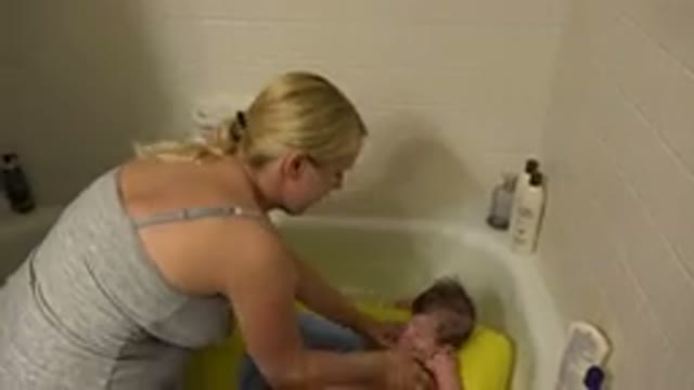 WESTMINSTER COLORADO-2015: Mother Bathing Her Child In Bathroom