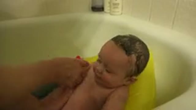 WESTMINSTER COLORADO-2015: Mother Washing Baby's Body in Yellow and Blue Bathtub