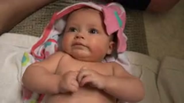 WESTMINSTER COLORADO-2015: Mother Applies Baby Oil to Infant in Tender Moment