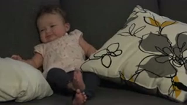 WESTMINSTER COLORADO-2015: A Baby Babbling And Sitting Up Propped Up On A Gray