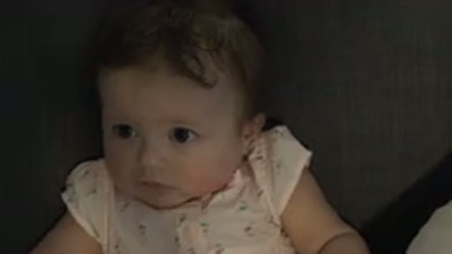 WESTMINSTER COLORADO-2015: Small Baby Girl Sitting on Sofa Watching Left