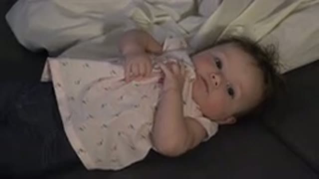 WESTMINSTER COLORADO-2015: Baby With Pink Shirt And Blue Pants Lying Down And Held