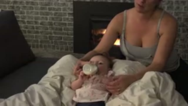 WESTMINSTER COLORADO-2015: A Woman In Gray Top Feeding Bottle Milk To Her Baby