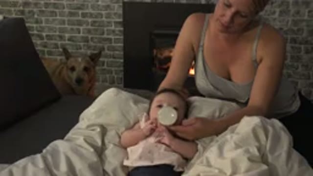 WESTMINSTER COLORADO-2015: Woman Wearing Gray Shirt Feeds Baby Wearing White