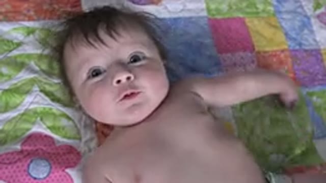 WESTMINSTER COLORADO-2015: A Baby Lying On His Back On A Blanket Wearing