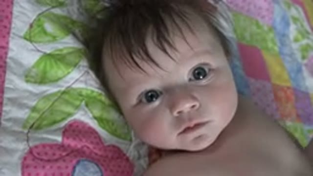 WESTMINSTER COLORADO-2015: Infant Laying On Blanket Staring At Camera