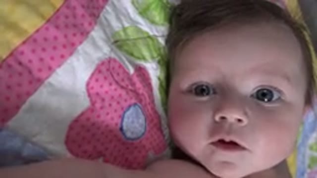 WESTMINSTER COLORADO-2015: Baby With Blue Eyes Looking To A Camera Lying In A Bed
