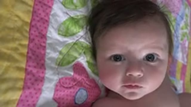 WESTMINSTER COLORADO-2015: Baby Lying On Pink Green And Yellow Quilt Looking At