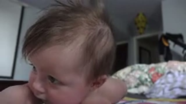 WESTMINSTER COLORADO-2015: Baby With Messy Hair Laying On The Floor Going To Sleep
