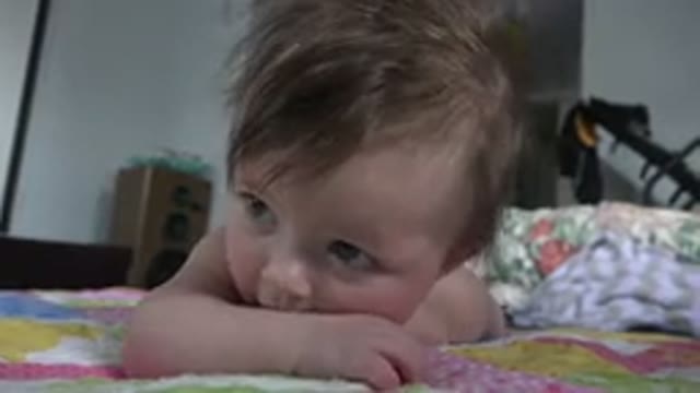 WESTMINSTER COLORADO-2015: Baby Lies On Pink And Purple Quilt Looking At Camera