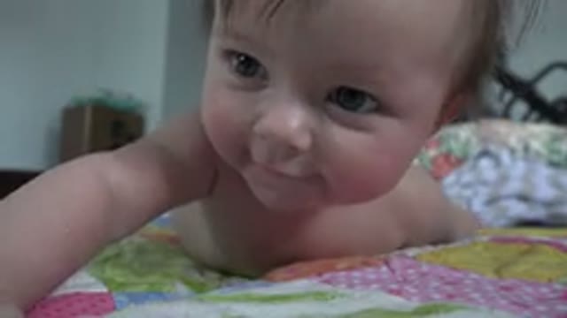 WESTMINSTER COLORADO-2015: Happy Baby Smiling On A Bed