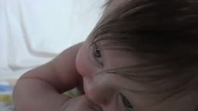 WESTMINSTER COLORADO-2015: A Small Baby Squirms and Talks in Baby-Talk on a Bed