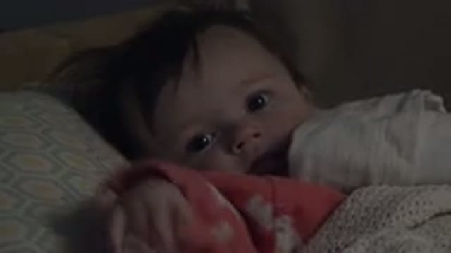 WESTMINSTER COLORADO-2015: Baby Wearing Pink Sleeper Lies On Pale Blue And Yellow Objects