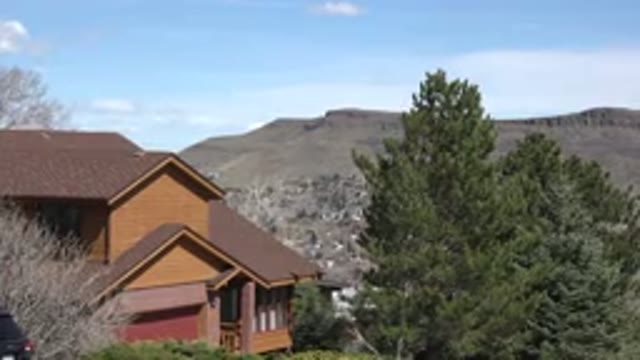 WESTMINSTER COLORADO-2015: A Large House and Tree Overlooking a Developed Suburban Valley