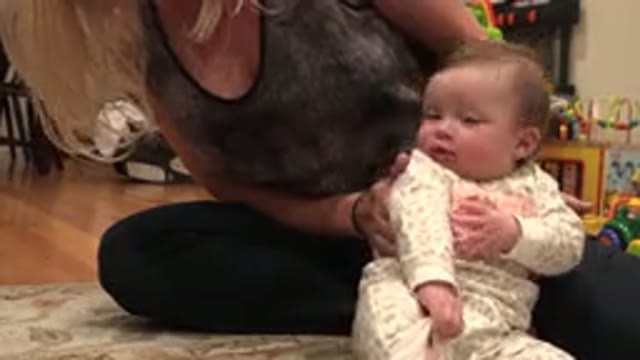 WESTMINSTER COLORADO-2015: Woman Wearing Gray Shirt Helps Baby Wearing Pink And
