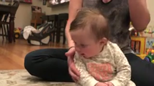 WESTMINSTER COLORADO-2015: Woman Wearing Gray Shirt Helps Baby Wearing White