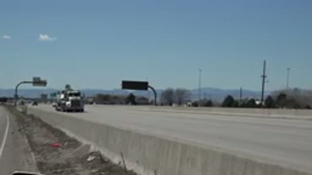 DENVER COLORADO-2015: Large Truck And Cars Passing On Wide Avenue