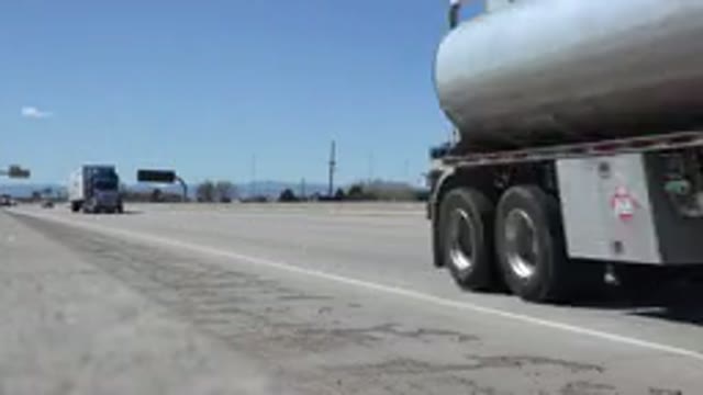 DENVER COLORADO-2015: Freight Trucks And Cars Pass On A Large Highway Rest Stop