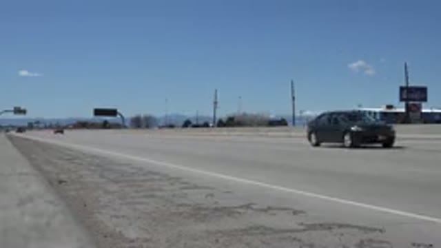 DENVER COLORADO-2015: Camera On Side Of Divided Highway Films Traffic Going By
