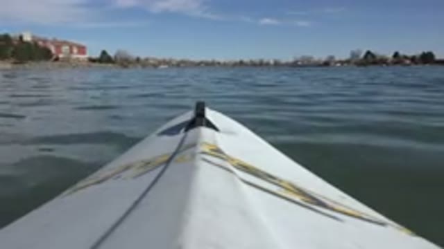 HIDDEN LAKE COLORADO-2015: A Boat Sailing in the Middle of a Pond Surrounded by Trees