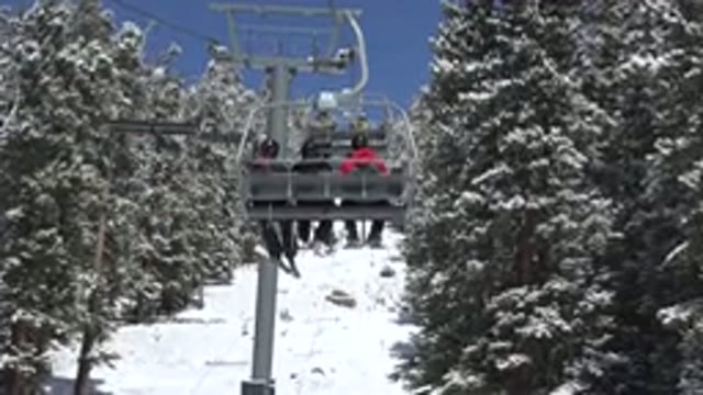 KEYSTONE COLORADO-2015: Three Skiers Going Up In A Ski-Lift