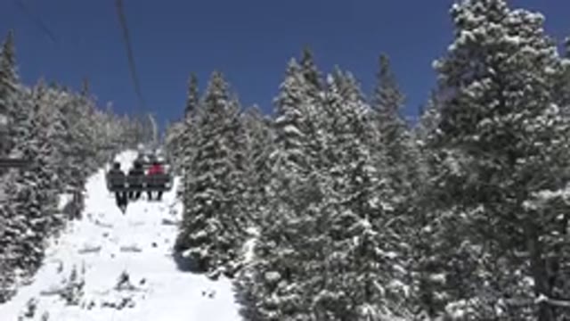 KEYSTONE COLORADO-2015: Three People Walk In A Chair Lift On The Snow-Covered