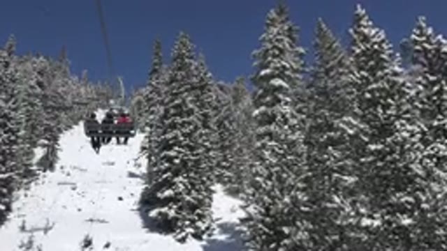 KEYSTONE COLORADO-2015: People Riding A Ski Lift Up A Snowy Mountain