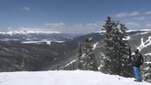 KEYSTONE COLORADO-2015: A Man Standing On The Top Of A Snow-Covered Mountain With Trees