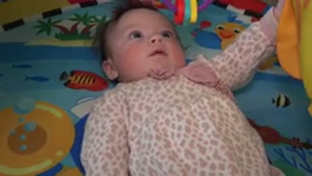 WESTMINSTER COLORADO-2015: Baby Laying Down and Playing With Toys