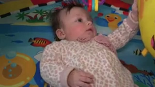WESTMINSTER COLORADO-2015: A Baby Girl Lying Entertained With Her Toys And Mobile