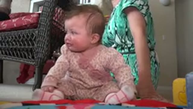 WESTMINSTER COLORADO-2015: A Woman And A Baby Sitting On The Floor