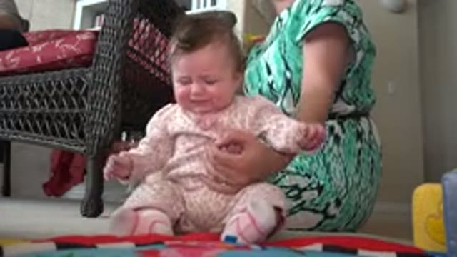WESTMINSTER COLORADO-2015: A Mother Tries To Calm Her Infant Baby By Giving Her
