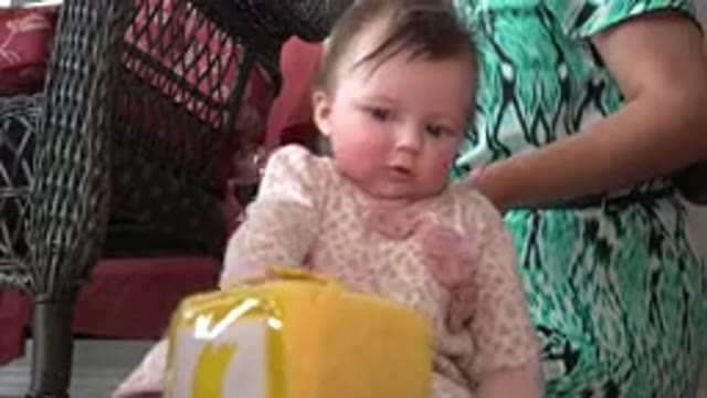 WESTMINSTER COLORADO-2015: Baby In Pink Clothes Reaches For A Yellow Object With