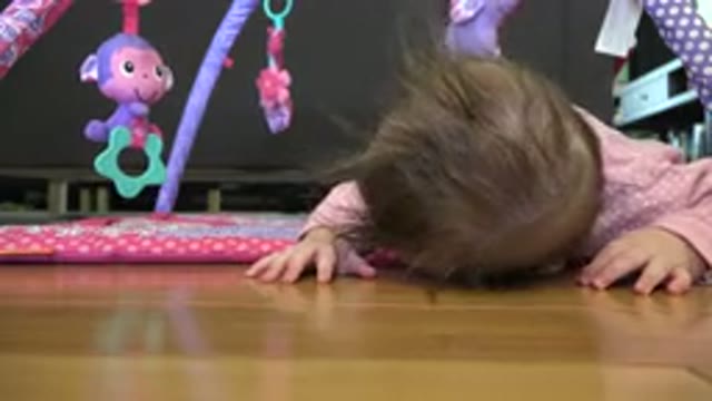 WESTMINSTER COLORADO-2015: Baby On Floor Under Toy Looks Up And Looks Into