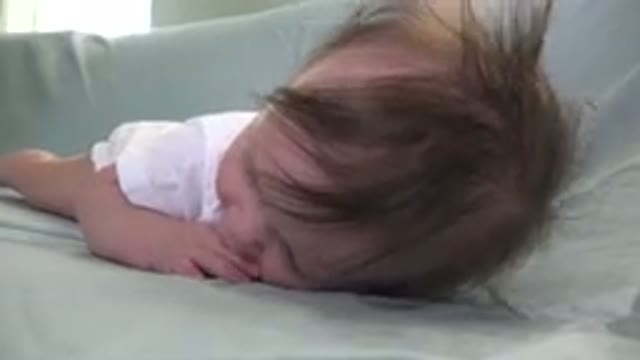 WESTMINSTER COLORADO-2015: Wriggling Infant on Sofa Gripping Sheet with Fingers