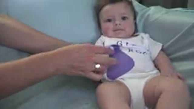 WESTMINSTER COLORADO-2015: Mother Adjusting Baby Who Is Almost Lying On The Couch