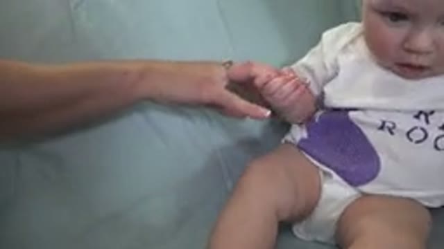 WESTMINSTER COLORADO-2015: Baby Sitting On The Blue Sofa Holds Her Mother's Hand