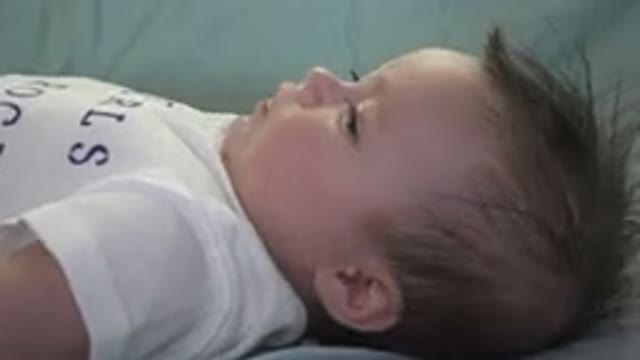 WESTMINSTER COLORADO-2015: Cute Baby Laying Down Wriggling in Soft Crib