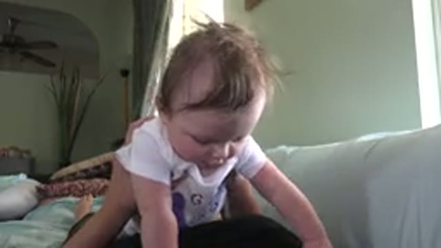 WESTMINSTER COLORADO-2015: A Cute Baby Being Caressed By Its Parent On A Couch