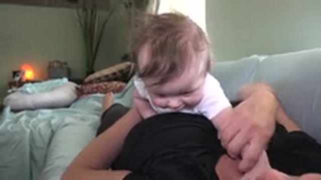 WESTMINSTER COLORADO-2015: Happy Baby Playing And Trying To Climb On Top Of His Mother