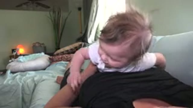 WESTMINSTER COLORADO-2015: Infant Wearing White Shirt Lies On Stomach Of Woman