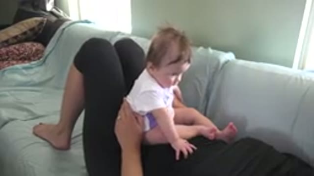 WESTMINSTER COLORADO-2015: Person Wearing Black Pants Lies On Green Sofa Holding Baby