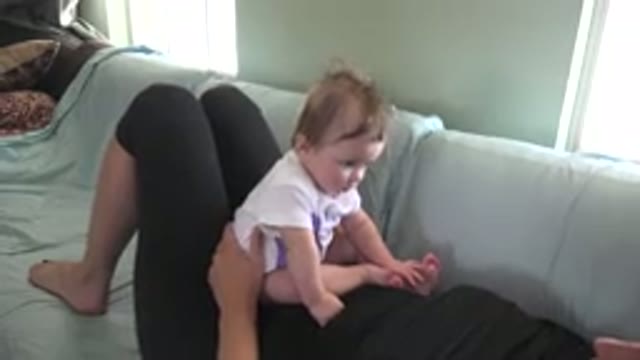 WESTMINSTER COLORADO-2015: Baby Sitting On Top Of Mother Laying On Couch