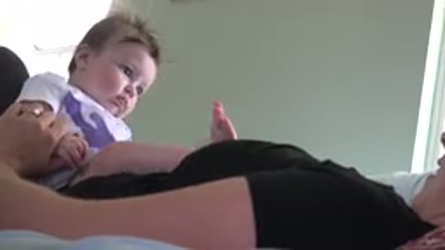WESTMINSTER COLORADO-2015: Blonde Woman Lying In Bed Playing With Baby Child