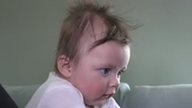 WESTMINSTER COLORADO-2015: Infant Wearing White Shirt Looks At An Off Screen