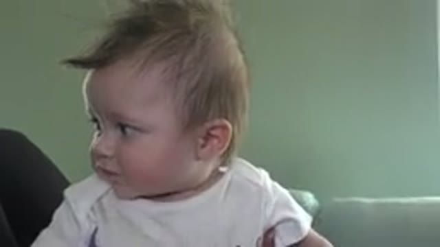 WESTMINSTER COLORADO-2015: Off Screen Person Sitting On Brown Sofa Holds Baby
